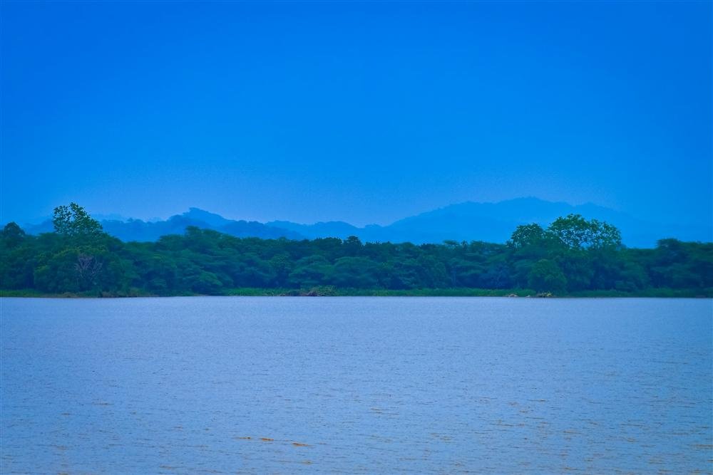 Wide view across Sukhna Lake toward the hills